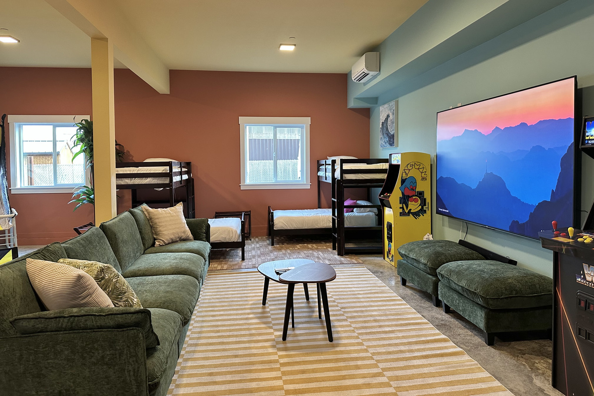 Lose the kids downstairs until dinner — the Flamingo Fun Room stacks arcade games, bunks, and a 100 inch big screen into one basement hangout.