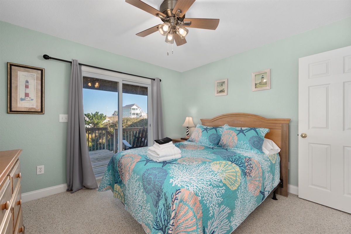 Cozy Queen bedroom with Smart TV and sliding door to deck.