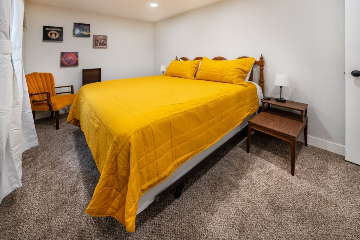 The other downstairs bedroom has a king size bed with a record player.