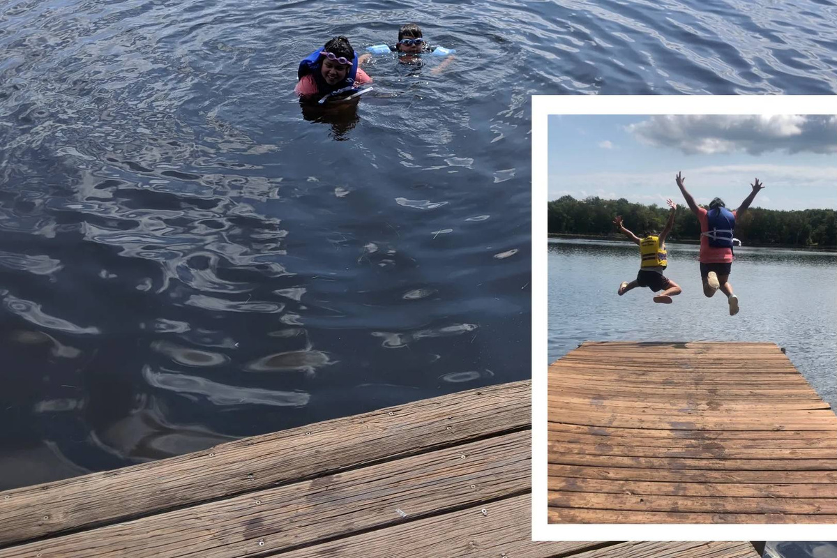 Kids jumping into the lake and swimming