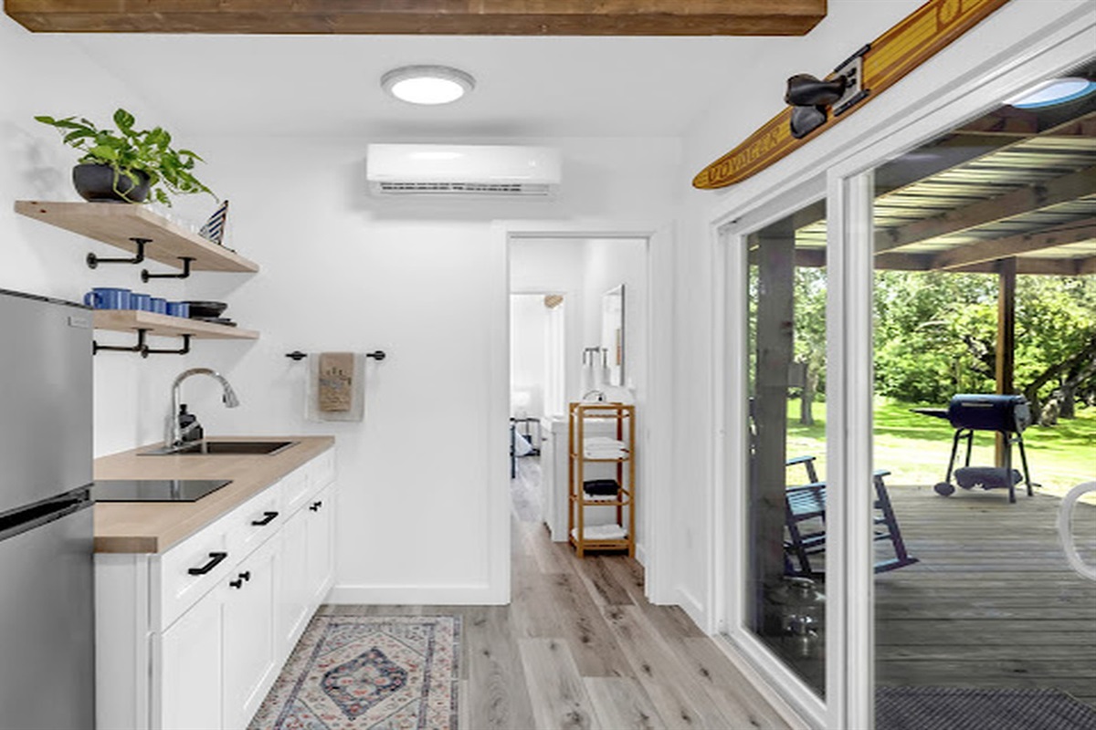 Stylish kitchenette with direct access to the covered porch and nature views.
