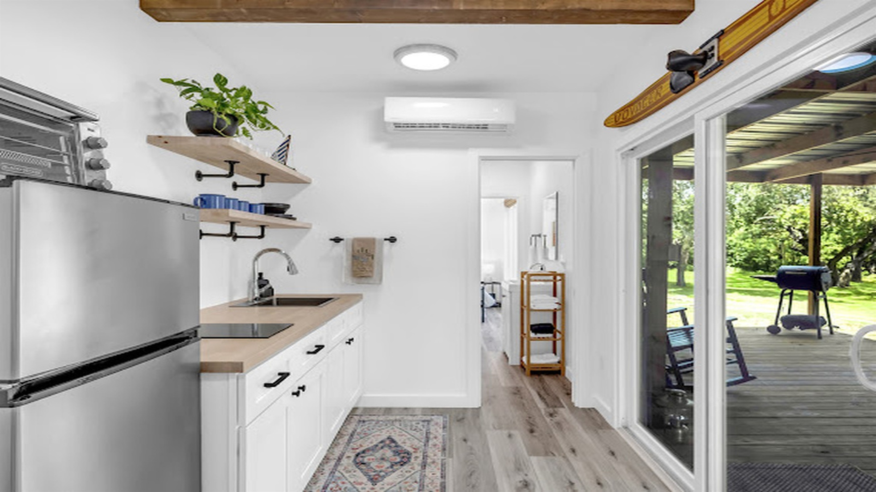Stylish kitchenette with direct access to the covered porch and nature views.