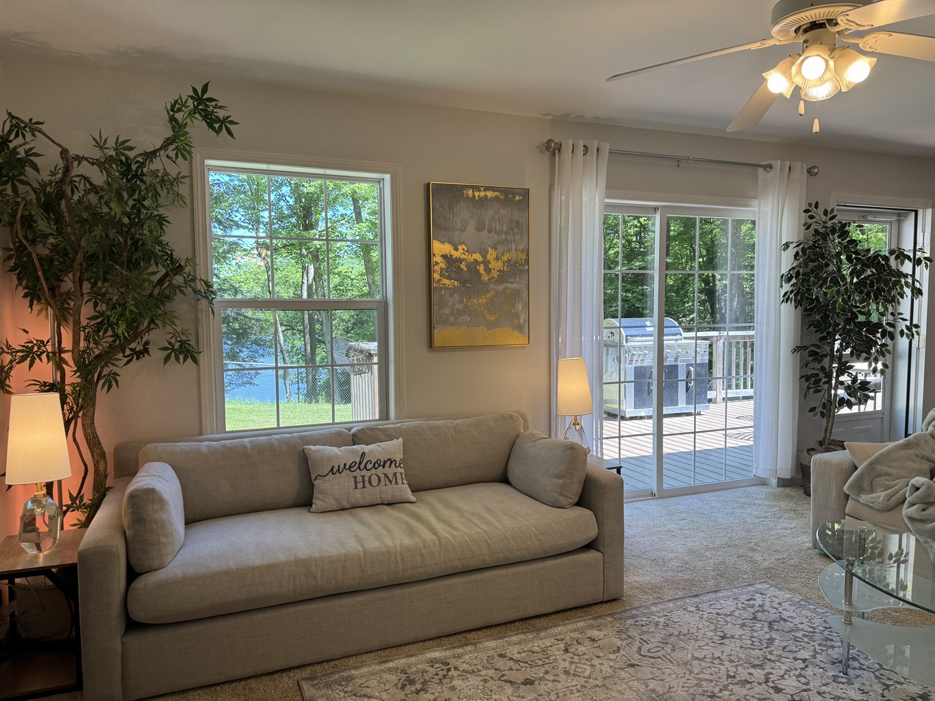 Living room with silders to deck and lakeview