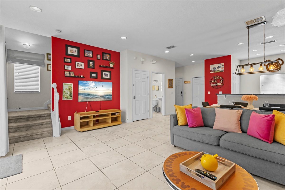 Spacious living room with smart TV and open layout connecting kitchen and dining area