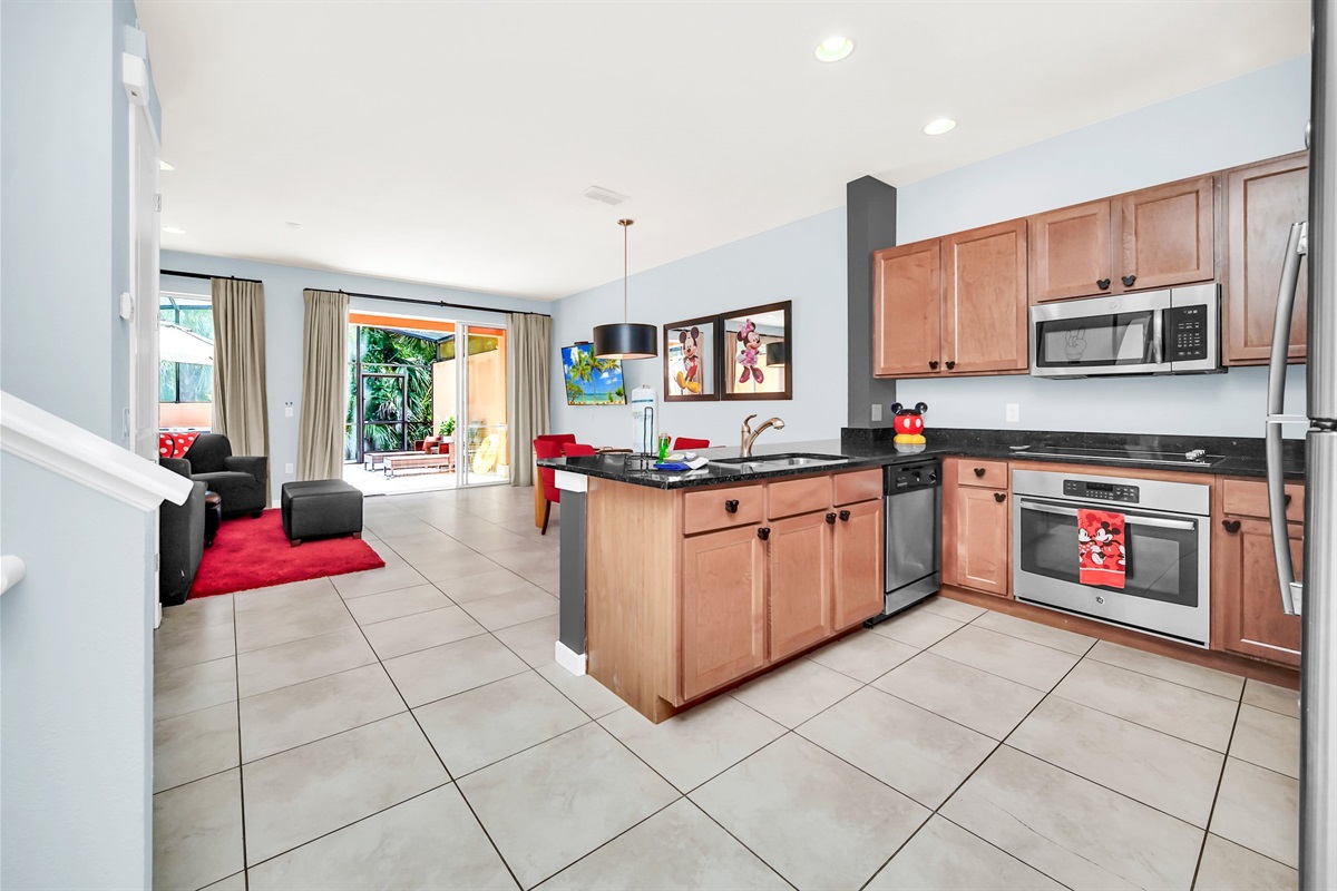 Large open kitchen with stainless appliances and solid surface countertops