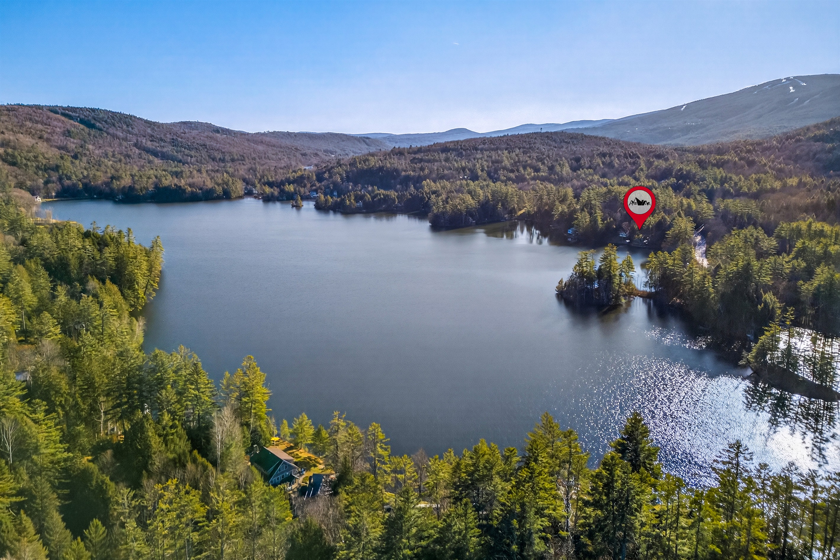 Aerial view highlighting the home and surrounding lakefront.