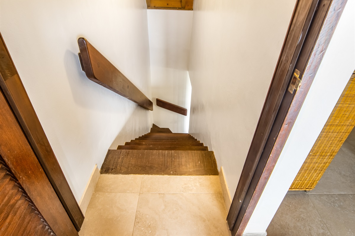 Across from the downstairs bathroom are the stairs that lead to the upstairs bedroom.