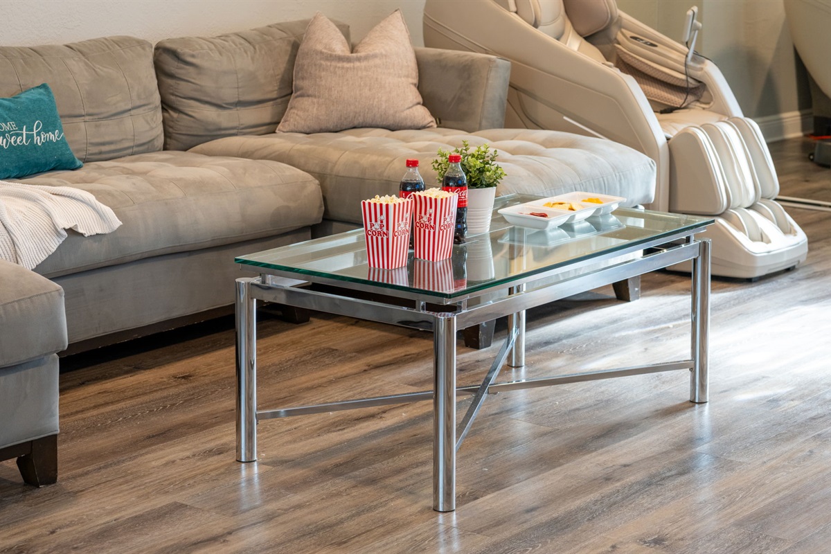 Ample seating, sleek surfaces, and open connectivity to the dining and kitchen areas make this living room perfect for hosting guests.