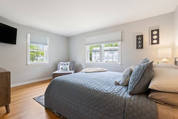 A bright and welcoming bedroom with a queen bed and nature’s backdrop!