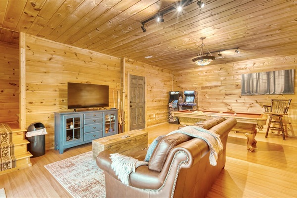 Game room with pool table, shuffle board, arcade games, and 50" smart tv