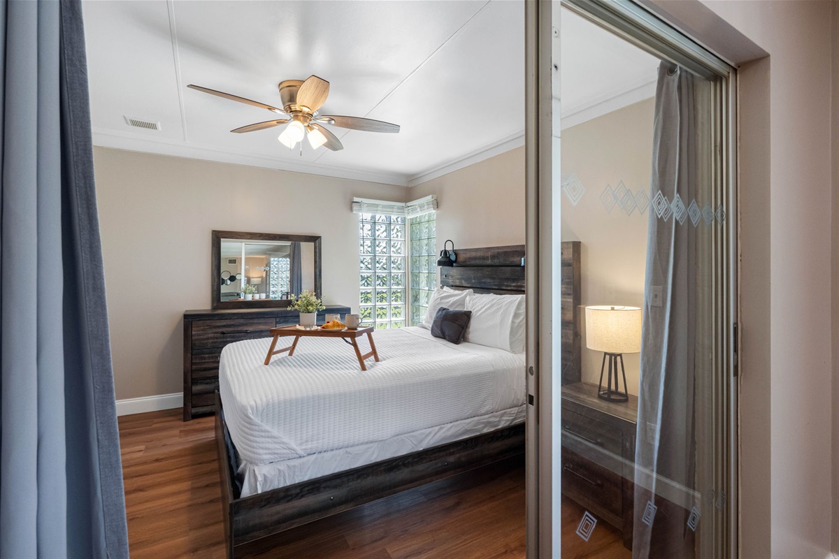 Large windows and glass accents allow plenty of natural light to flow in, giving the room a bright and refreshing feel.