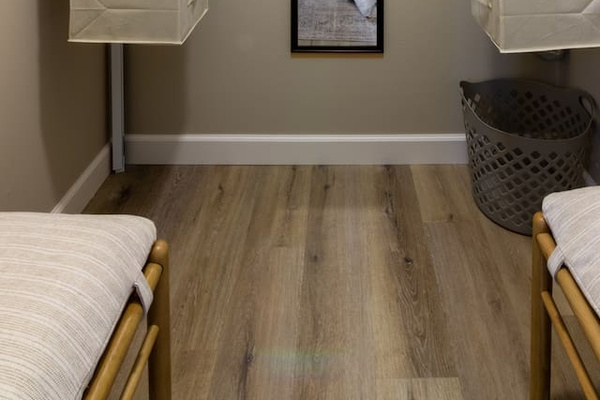 A quiet corner of the bedroom, with warm wood floors and simple, cozy styling.