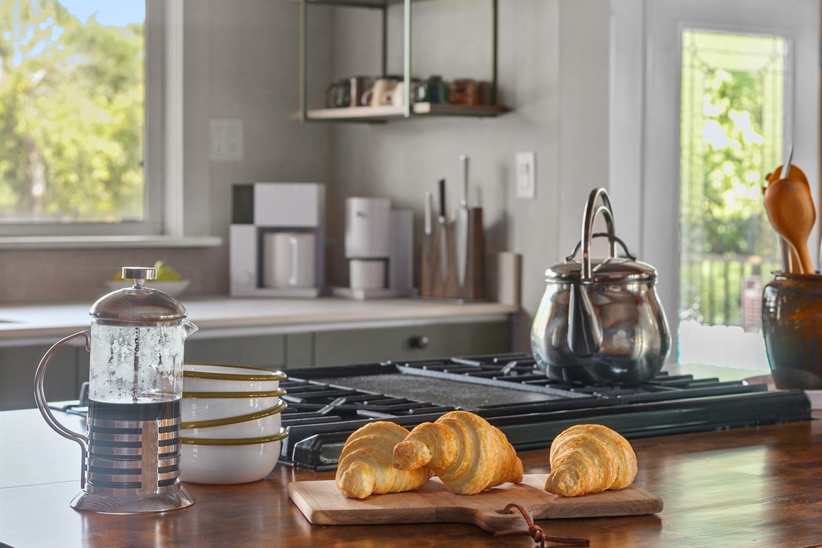 In the heart of the kitchen, the gas stove brings both warmth and function to the space. Its sleek design beneath the bold vent hood makes cooking feel effortless, whether you’re preparing a quick breakfast or a family-style dinner.