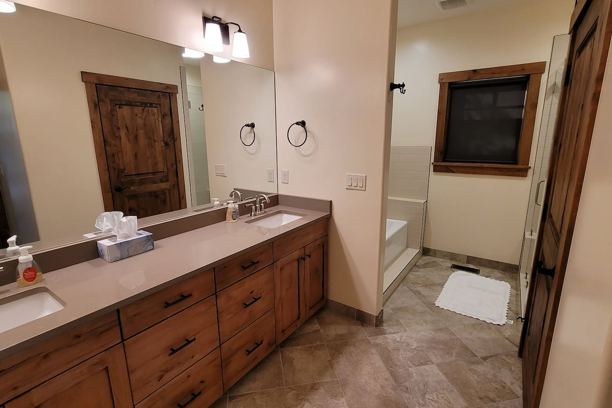 Main floor master bathroom with separate tub, shower and toilet room
