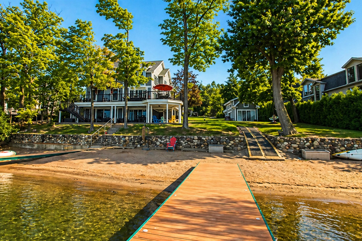 Enjoy direct access to the lake with a private sandy beach, dock, and spacious yard perfect for relaxing by the water.