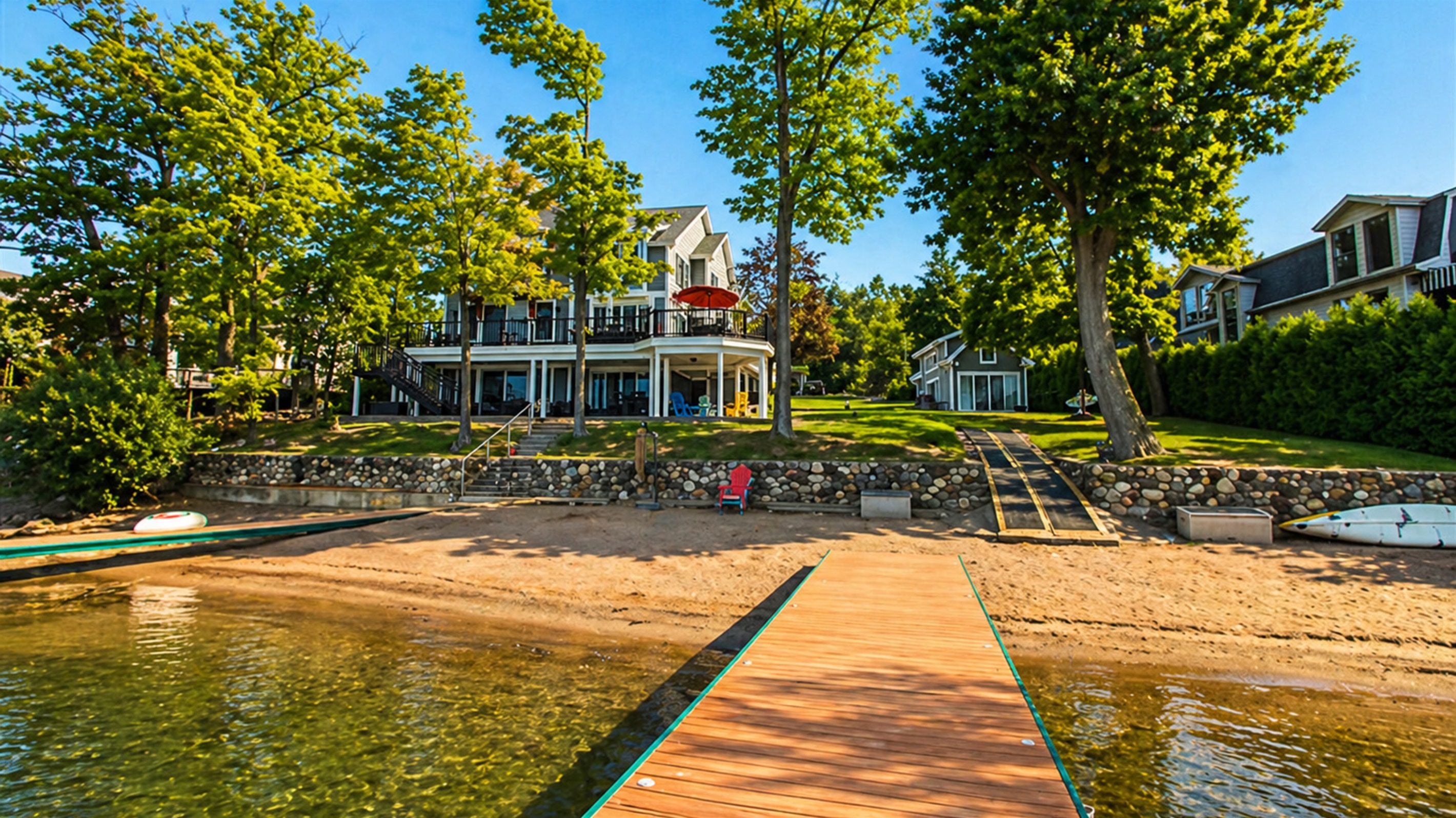 Enjoy direct access to the lake with a private sandy beach, dock, and spacious yard perfect for relaxing by the water.