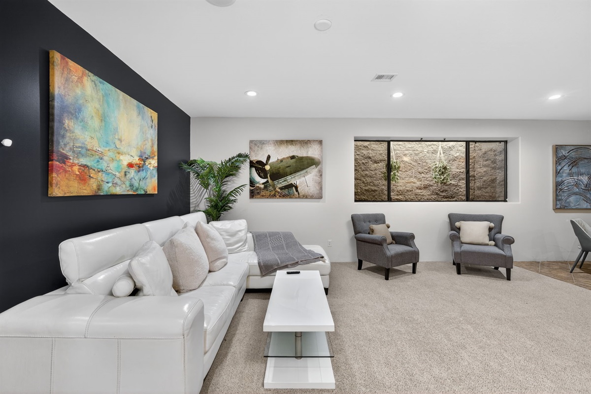 Bright lower-level lounge area offers a second entertainment space ideal for families traveling together
