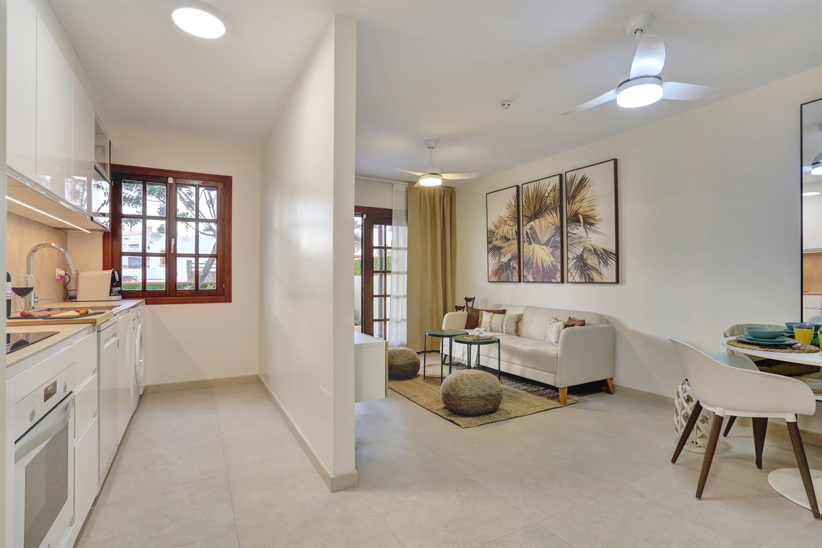 Modern, fully equipped kitchen seamlessly integrated into a spacious open-plan living and dining area - perfect for a comfortable and practical stay.