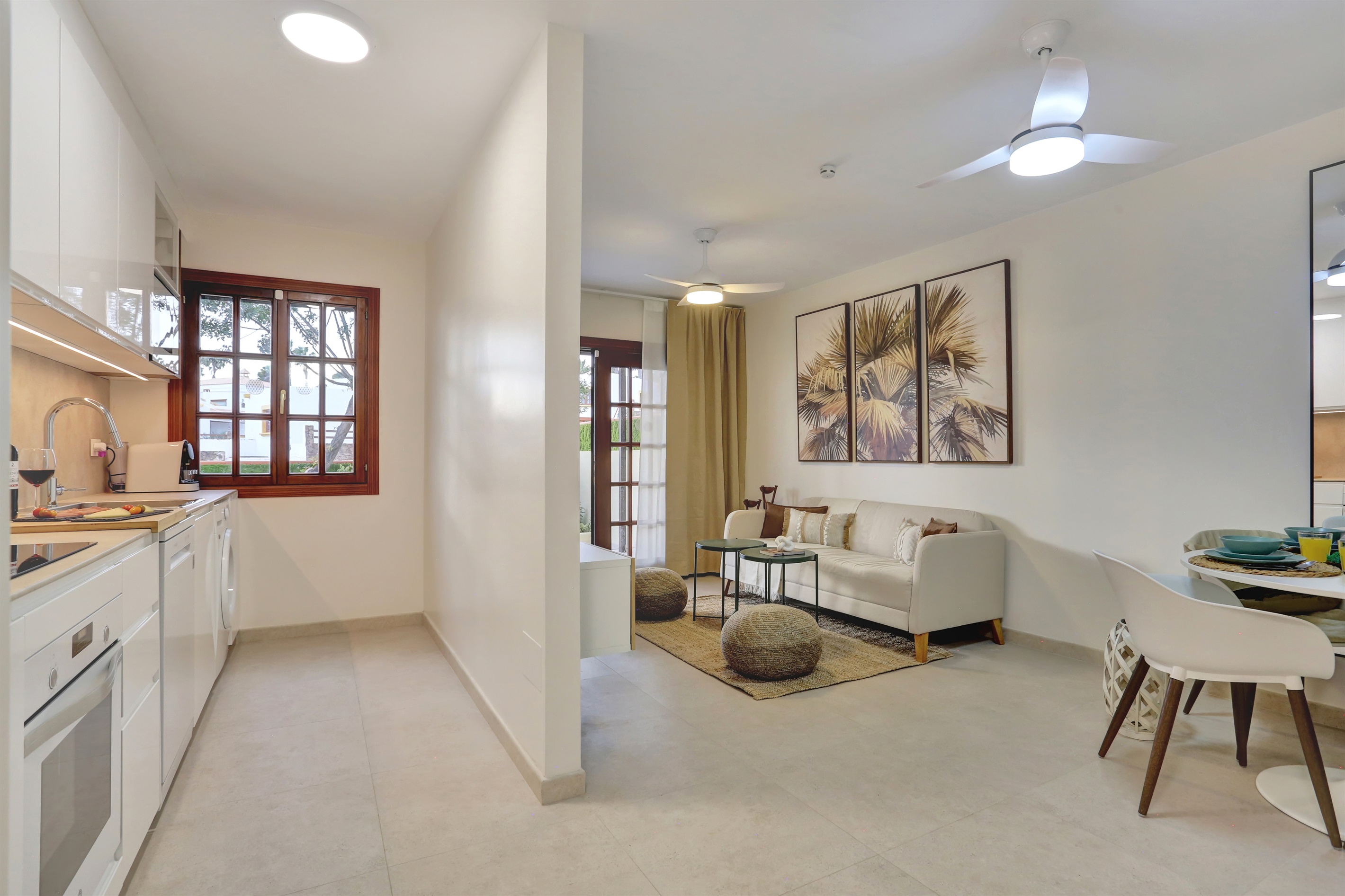 Modern, fully equipped kitchen seamlessly integrated into a spacious open-plan living and dining area - perfect for a comfortable and practical stay.