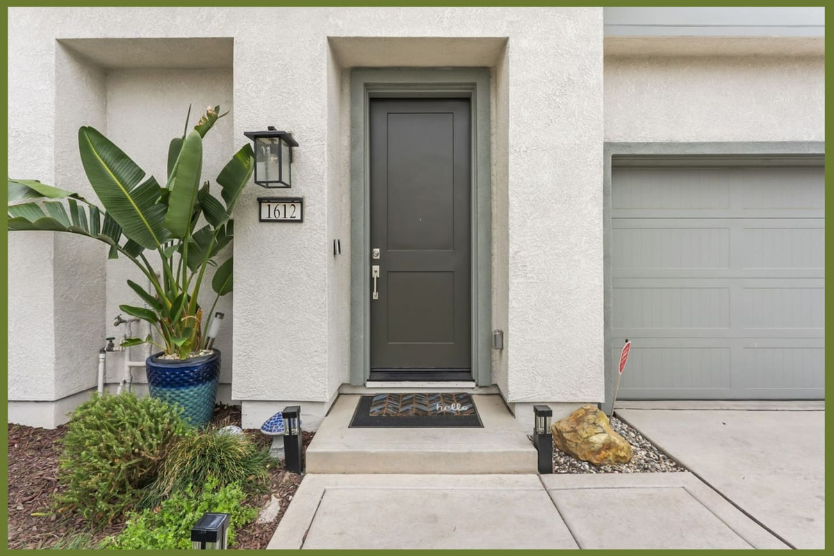Front entry with garage access, covered doorway, and simple landscaping for an easy arrival.