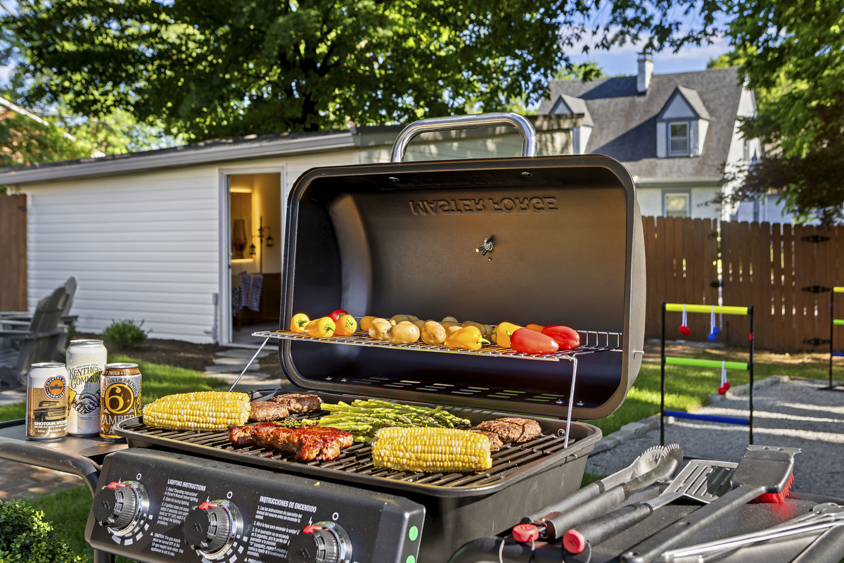 The backyard Weber is fired up for a proper Kentucky cookout, with corn, ribs, peppers, and asparagus sizzling on the grill.