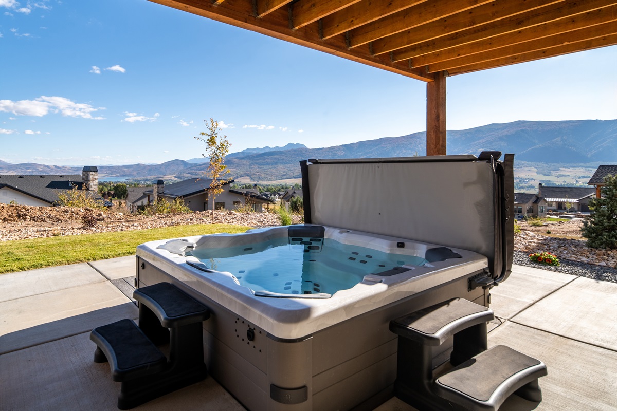 Relax and unwind in the hot tub, enjoying the mountain views and the glow of the fireplace in this stylish mountain retreat.