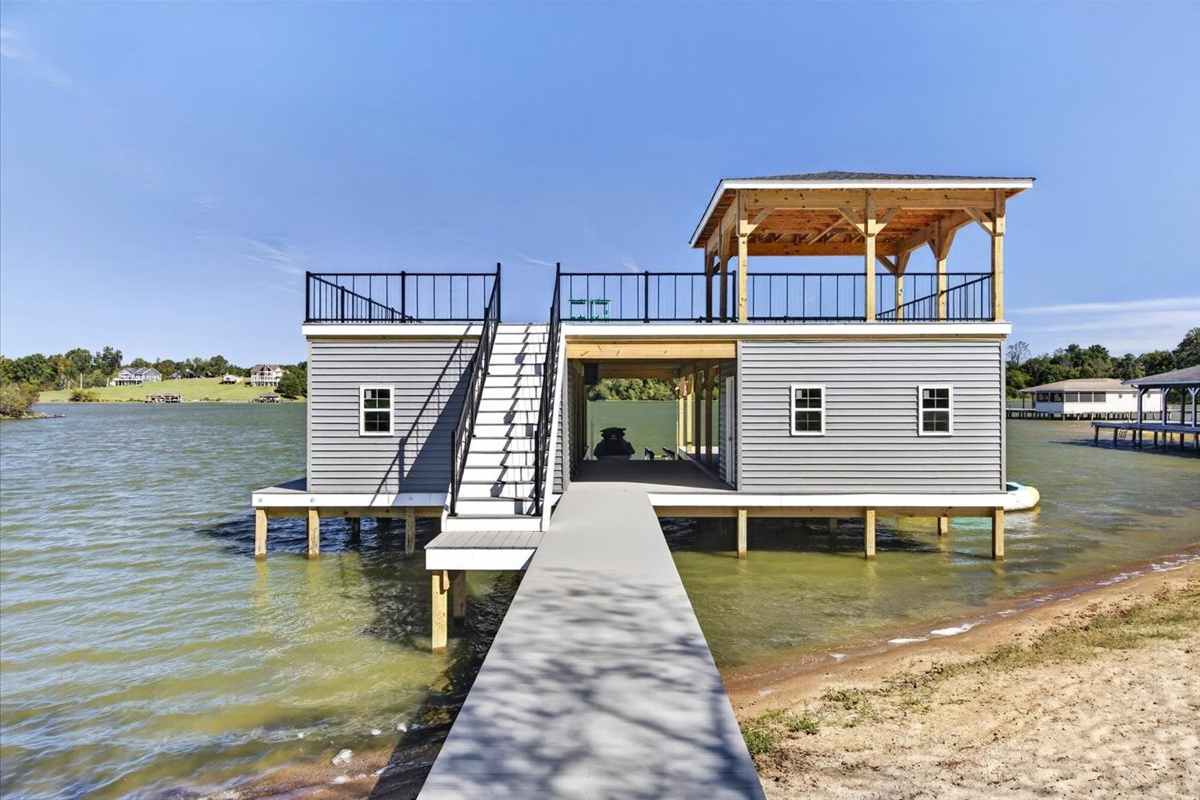 Private walkway leads directly from the sandy shoreline to the spacious boathouse.