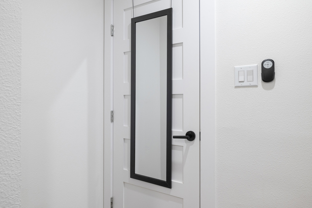 Step into style with this sleek door featuring a chic mirror and modern finishes!