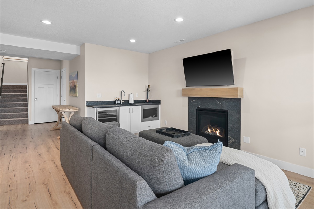 Downstairs living area with fireplace—ideal for movie nights.