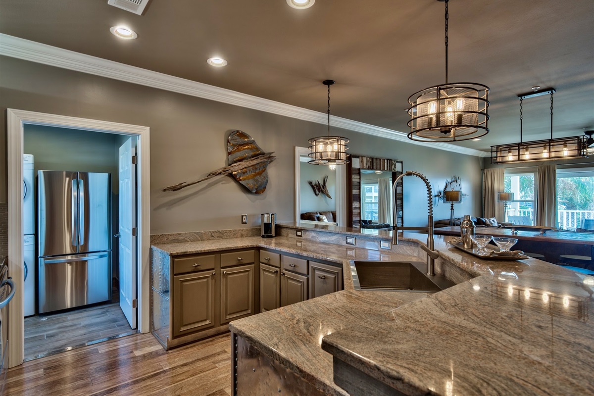Kitchen with NOLA faucet, zero radius sink and stainless appliances.