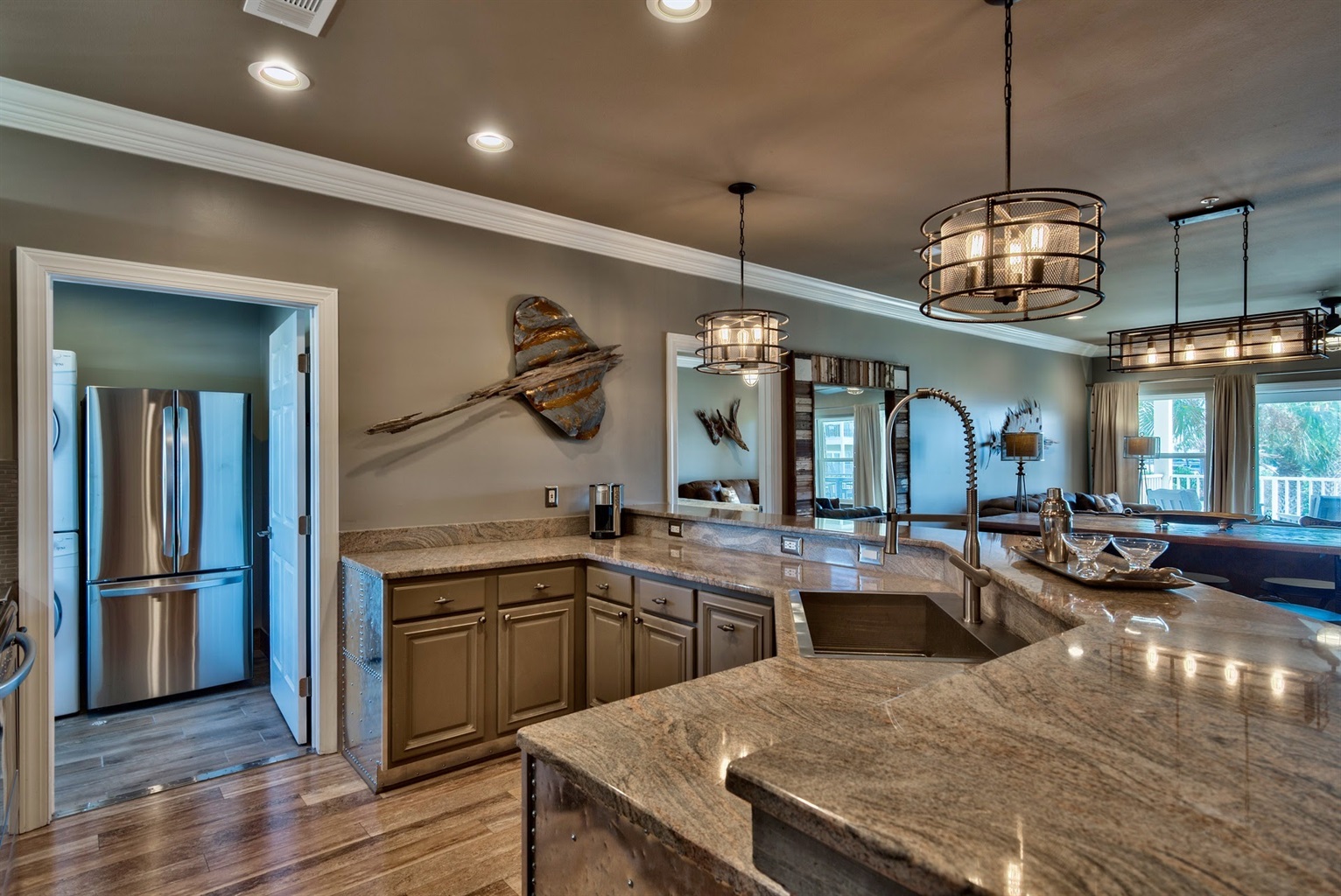 Kitchen with NOLA faucet, zero radius sink and stainless appliances.
