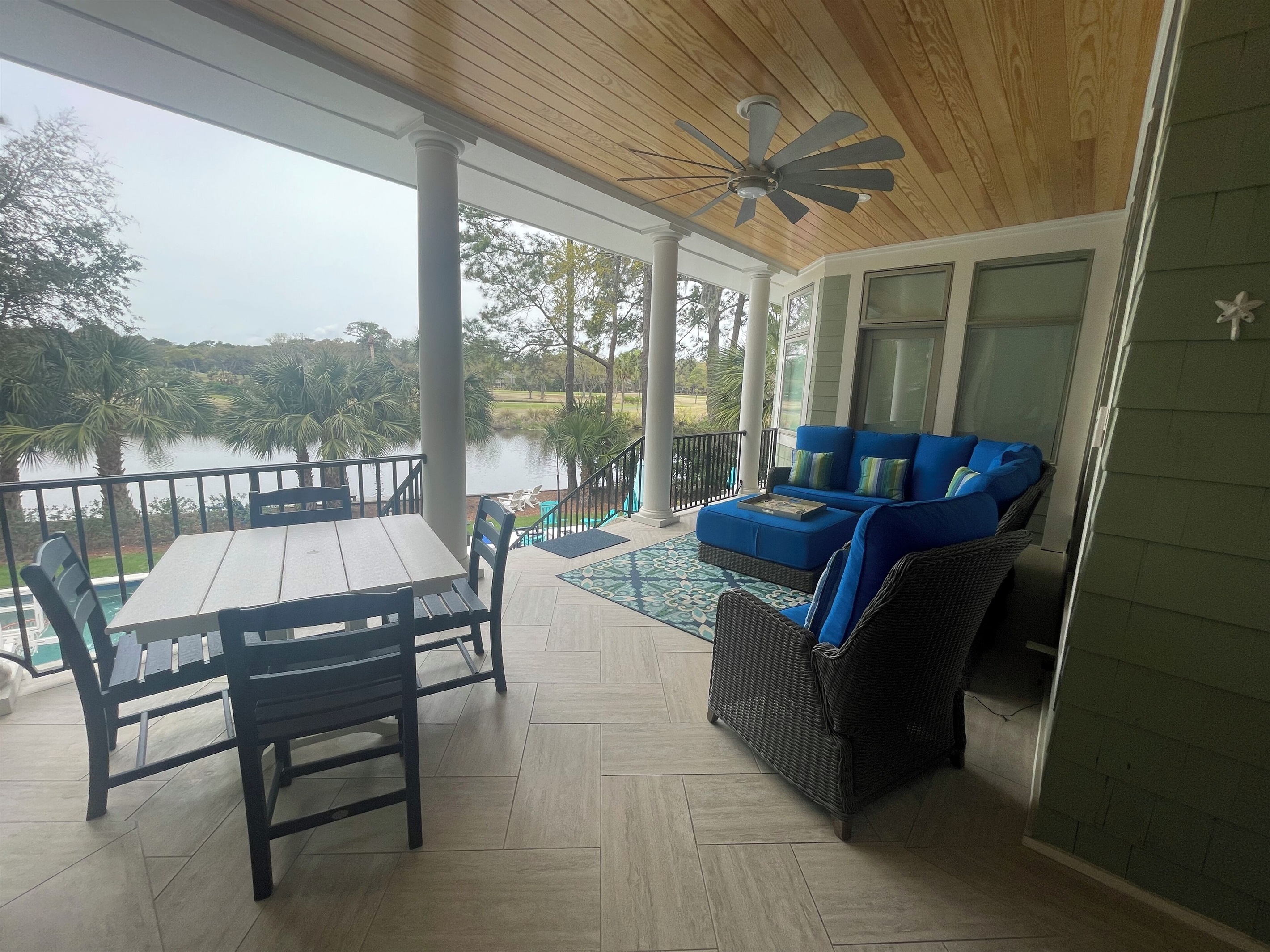 Rear porch with views of pool, lagoon and golf course.  Perfect for relaxing.