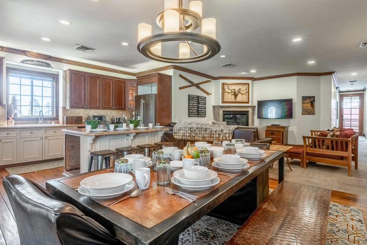 The heart of the Refined Rustic Retreat features a generous dining table perfect for shared meals, celebrations, and game nights, all open to the fully equipped kitchen and cozy living space.
