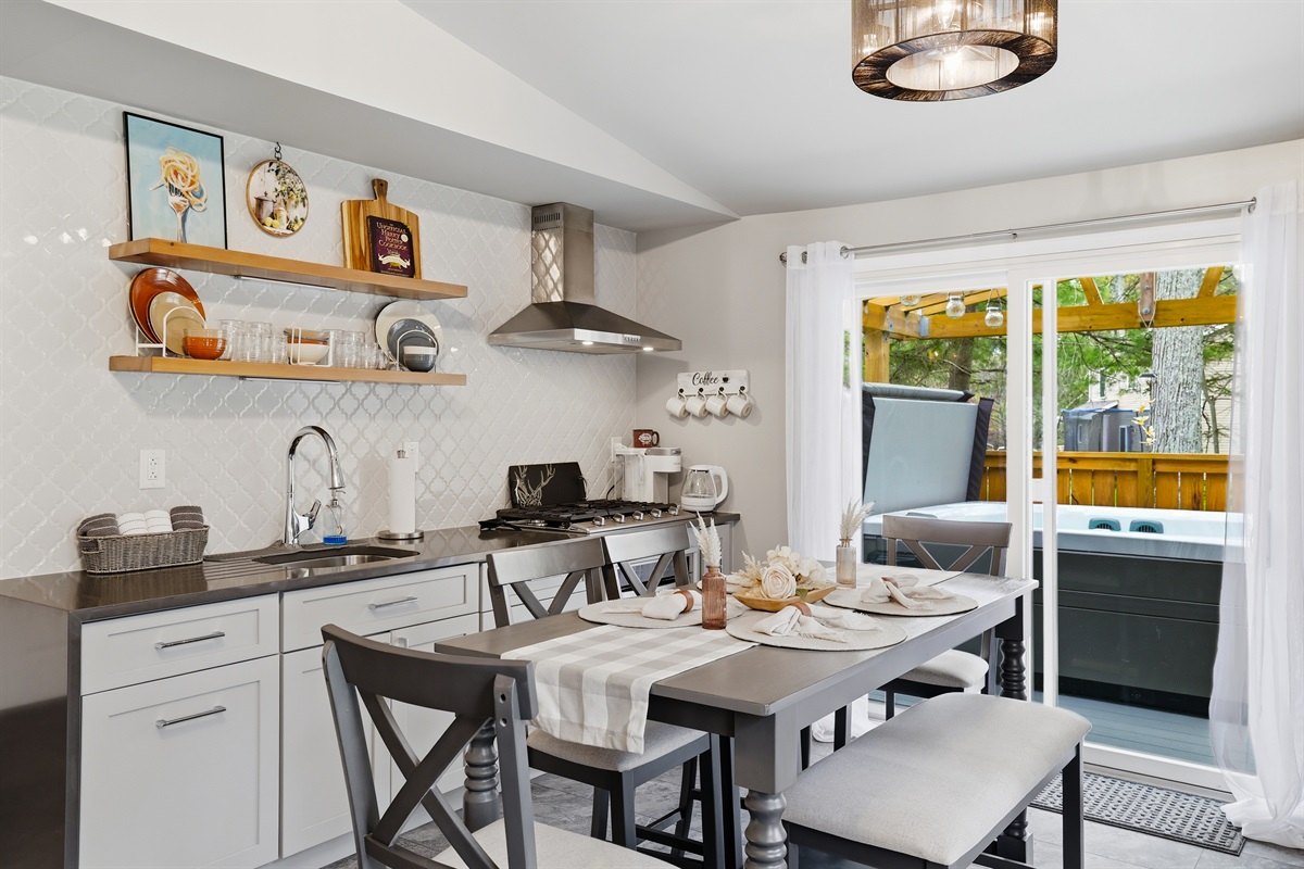 Share meals, stories, and memories around the kitchen table, connecting both the living room and the deck. 