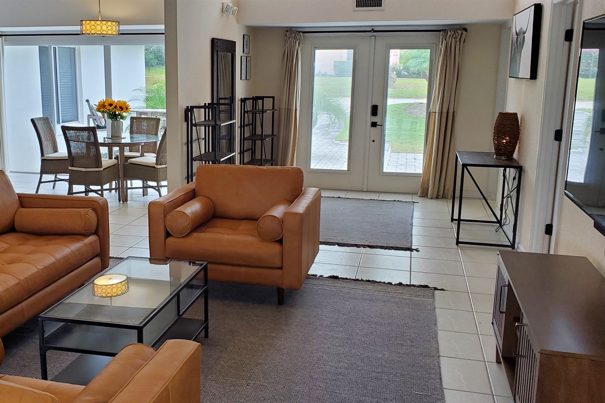 View of living room, dining room and entryway from lanai