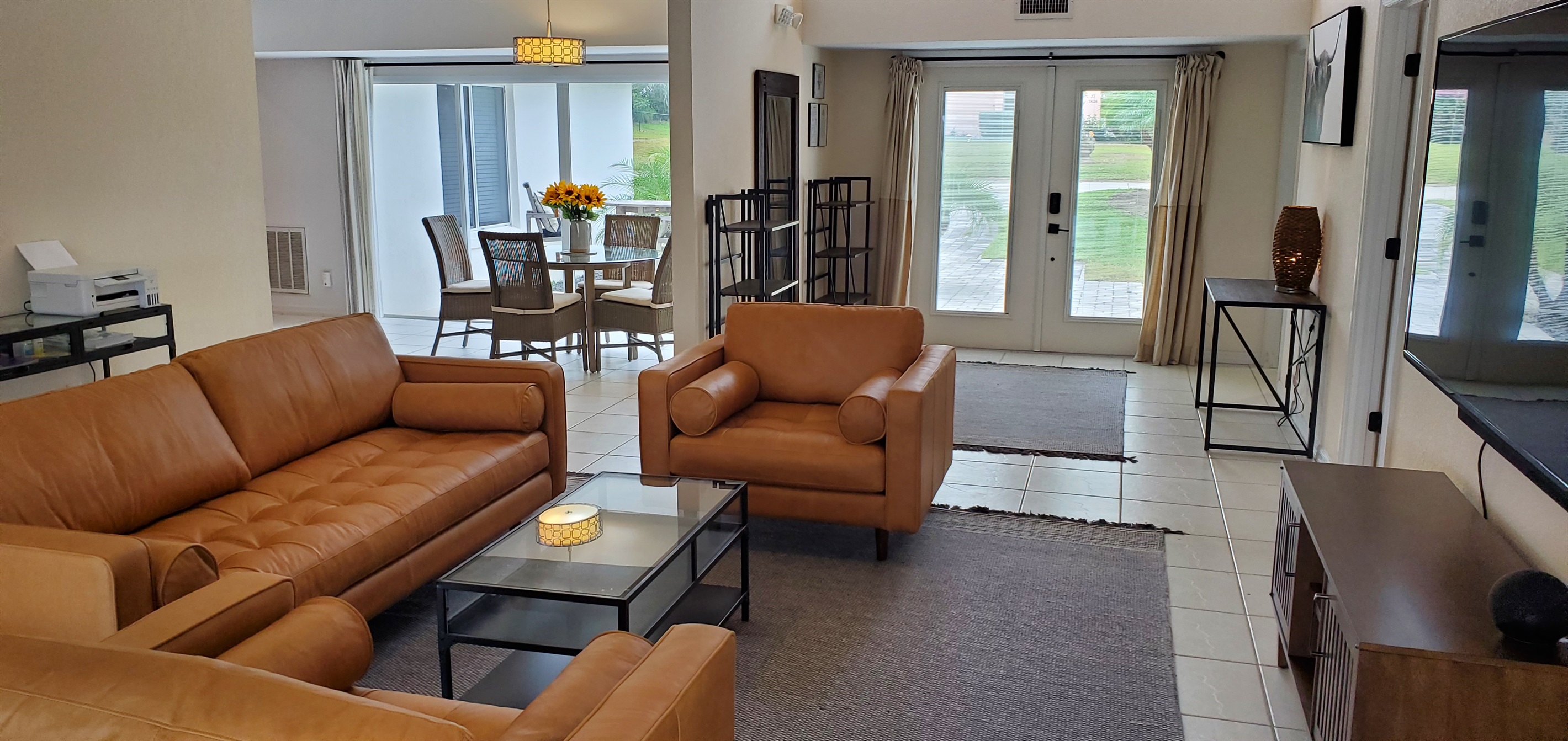 View of living room, dining room and entryway from lanai