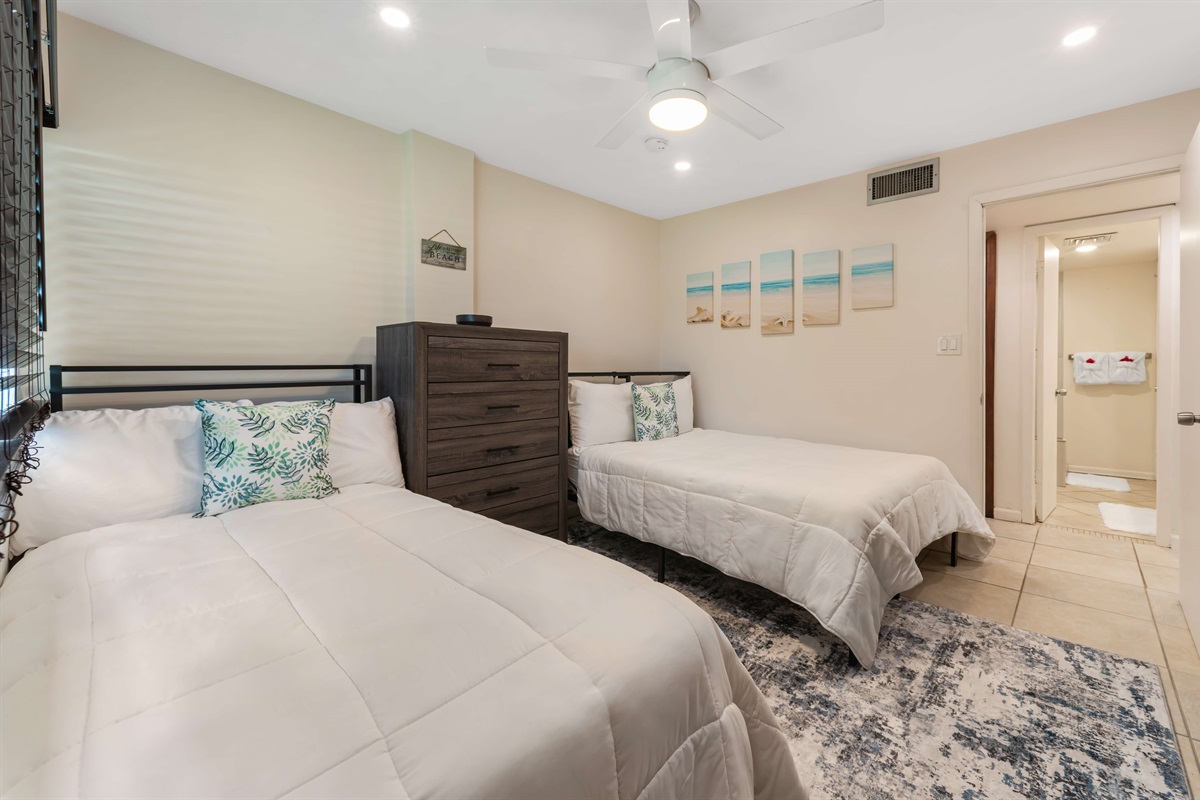 The perfect spot for families or a couple in this guest bedroom with a double and twin bed.