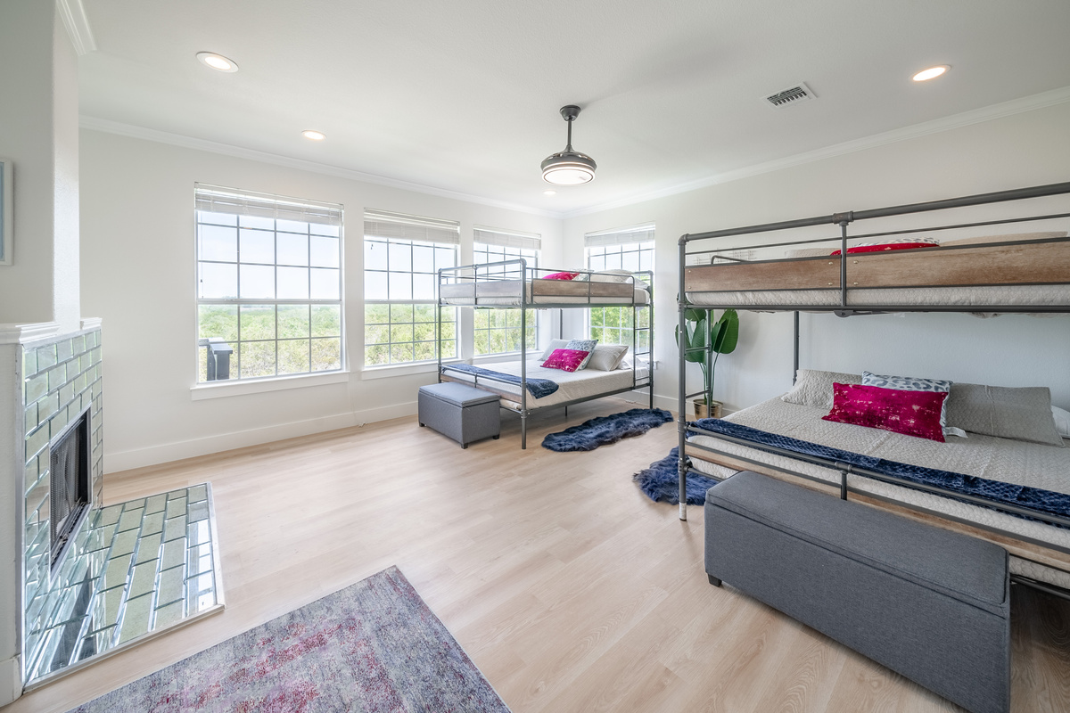 Bright primary suite bathed in natural light from oversized windows.