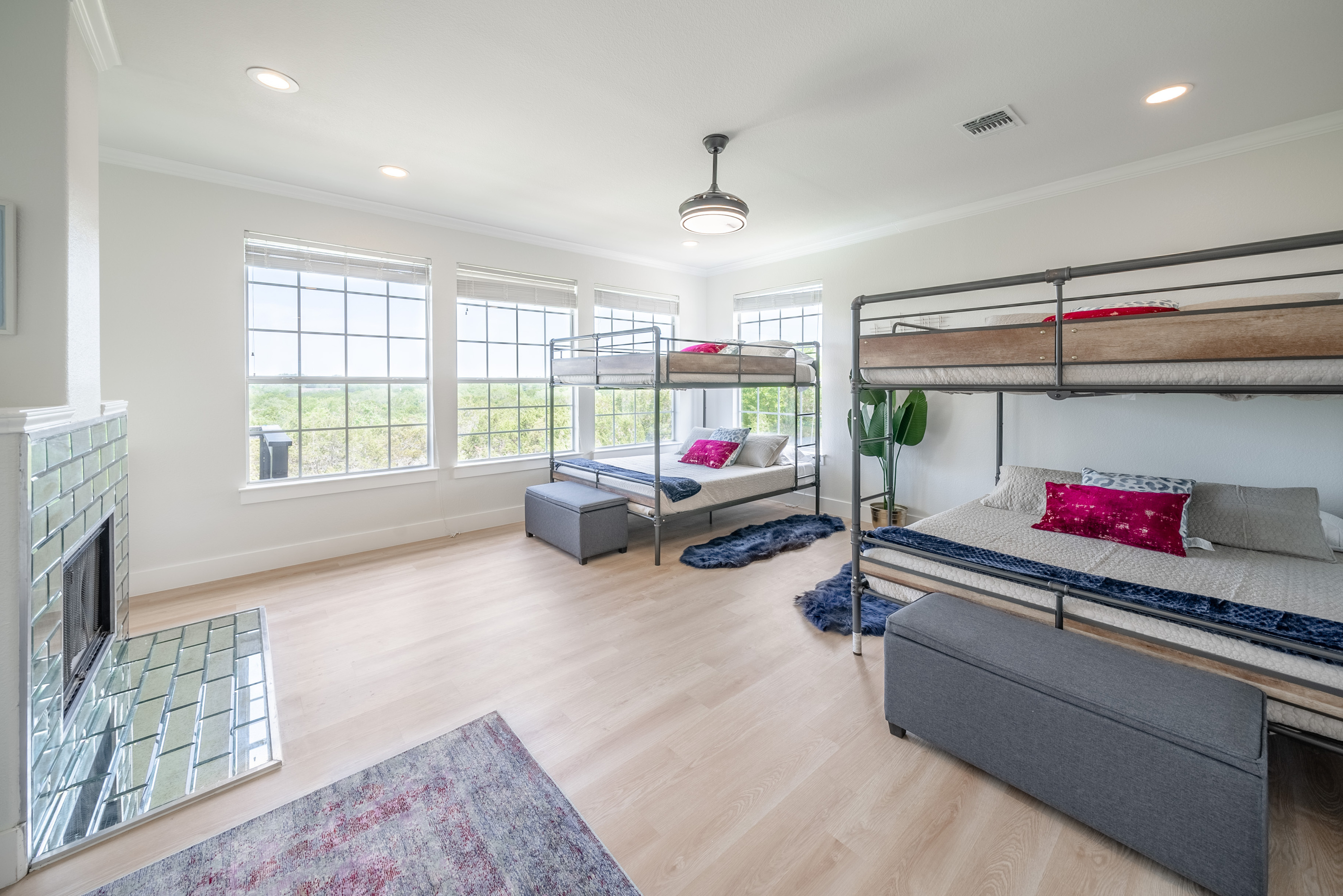Bright primary suite bathed in natural light from oversized windows.