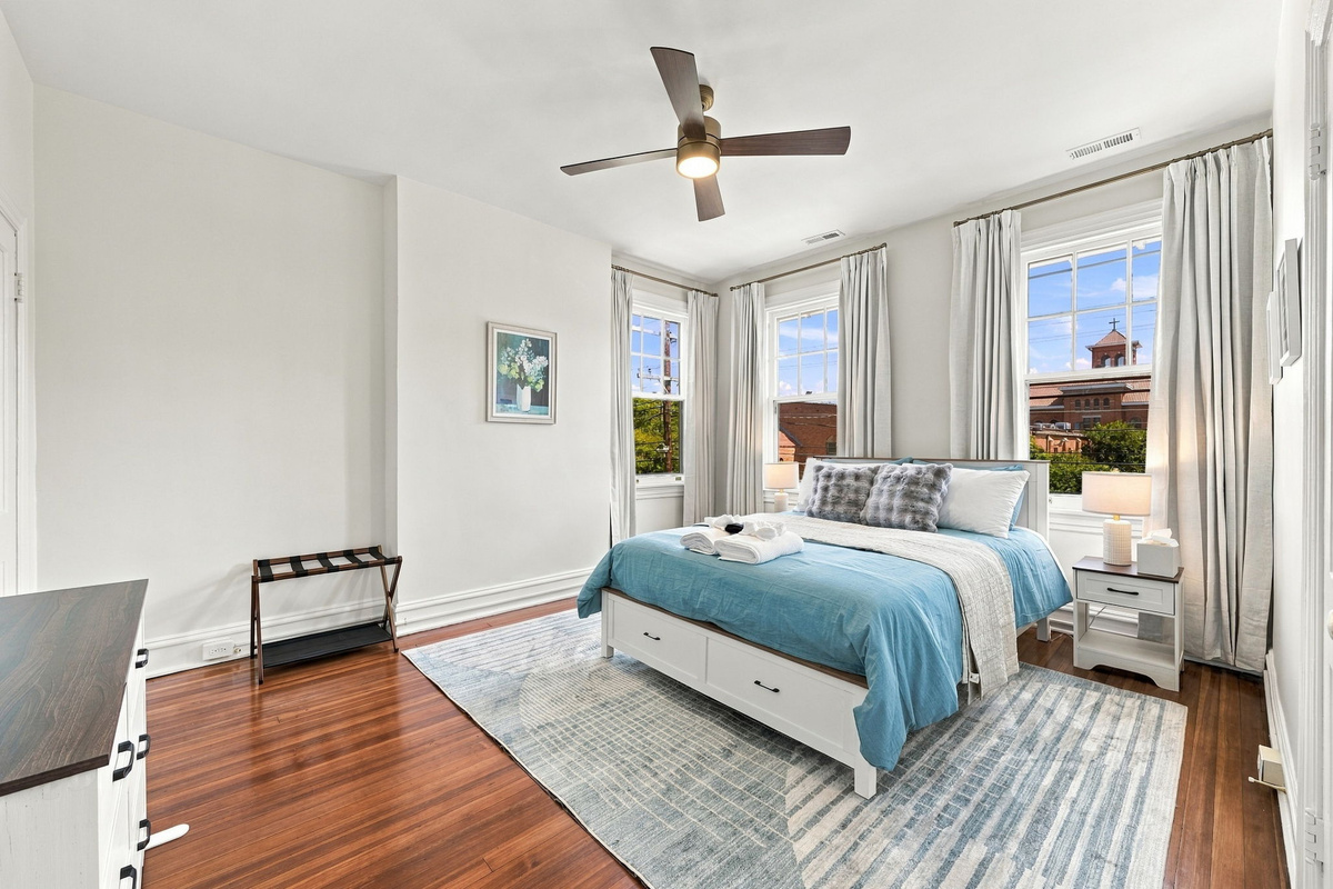 Serene Escape: Bright bedroom with stylish decor, large windows, and inviting views!