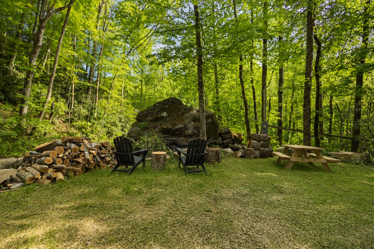Relax outdoors with a fire pit, Adirondack chairs, and peaceful wooded surroundings.