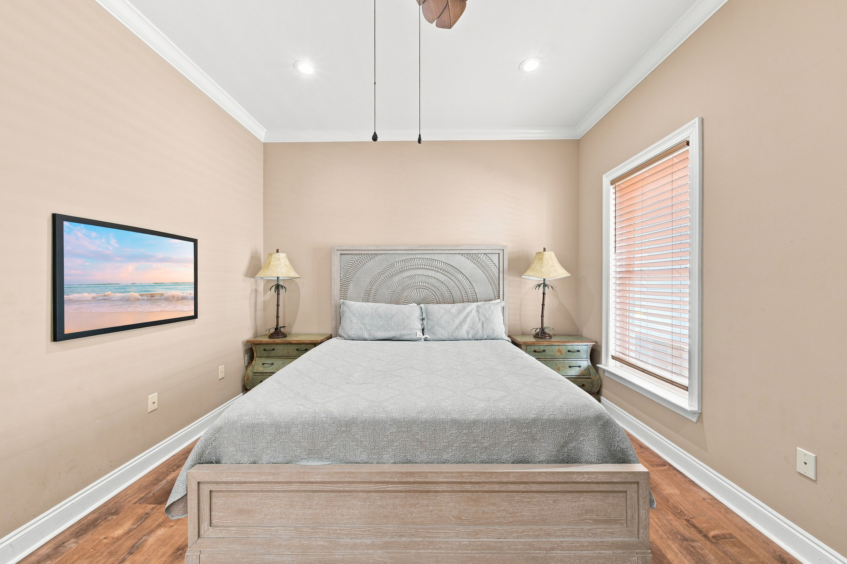 Bedroom with plush bedding and a ceiling fan