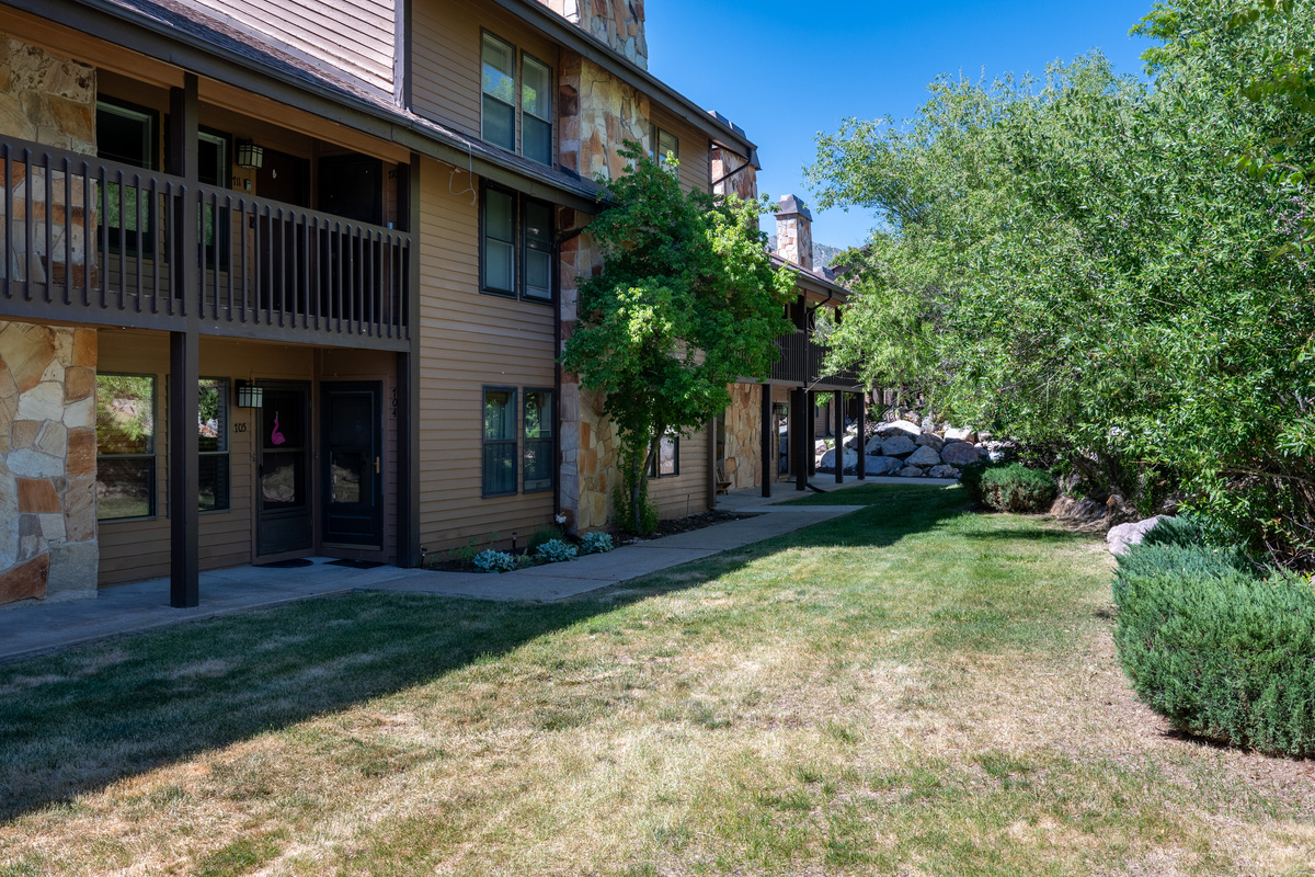 Exterior view of the building with beautifully maintained grounds and easy access to community amenities.