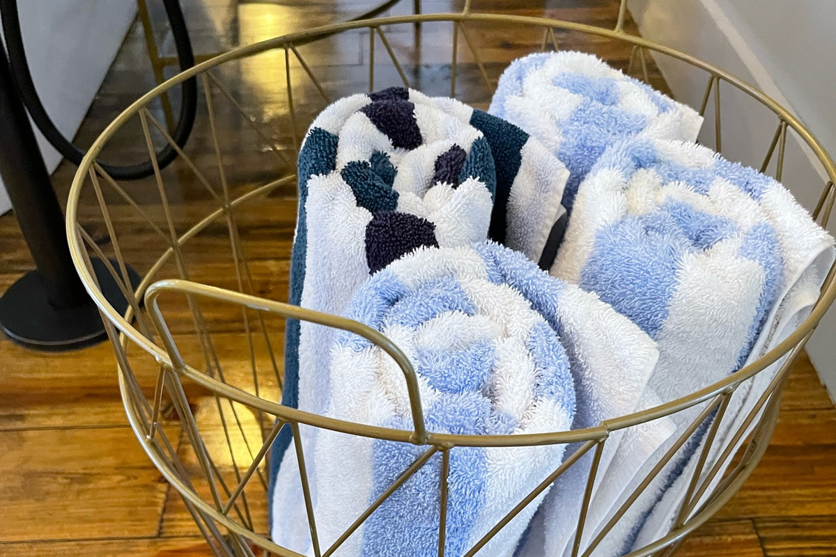 A basket of fluffy towels to use for either getting out of the soaking tub, or for using for after relaxing in the hot tub.