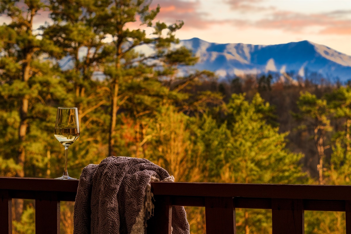 A glass of wine and an amazing mountain view from the balcony are perfect for romantic holidays in Sevierville.