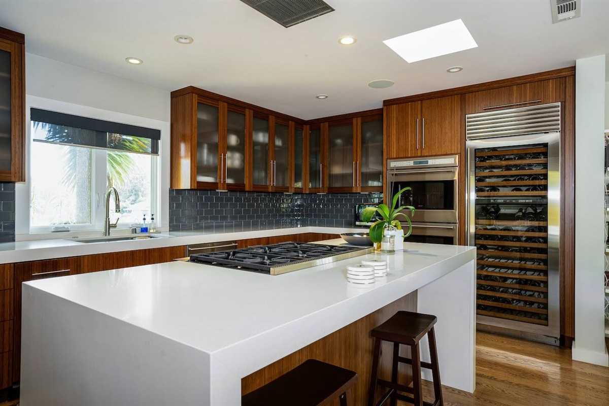 Fully stocked chef's kitchen with 8 person dining table and two person island seating.