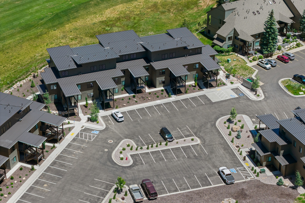 Aerial perspective showcasing the community and surrounding mountains. Note the ample parking space available.