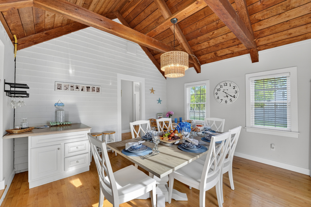 Spacious dining room with vaulted ceilings and coastal-inspired décor, creating the perfect setting for group gatherings.