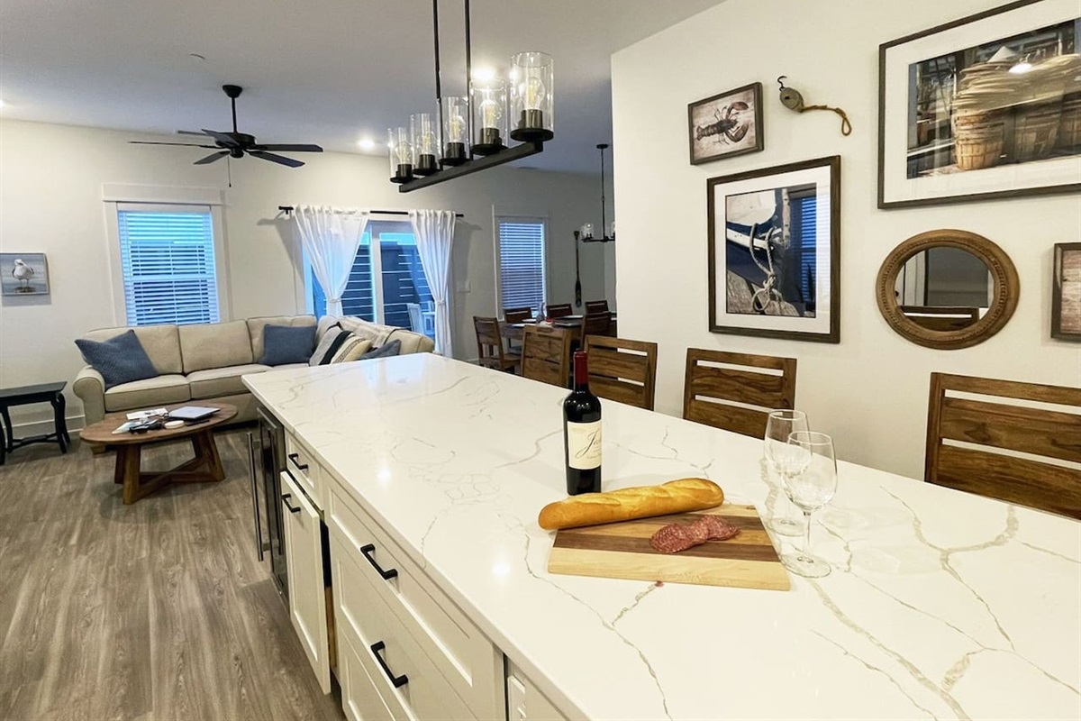 Spacious open floor plan featuring a fully equipped kitchen, dining area, and comfortable living room designed for gathering and relaxing together.