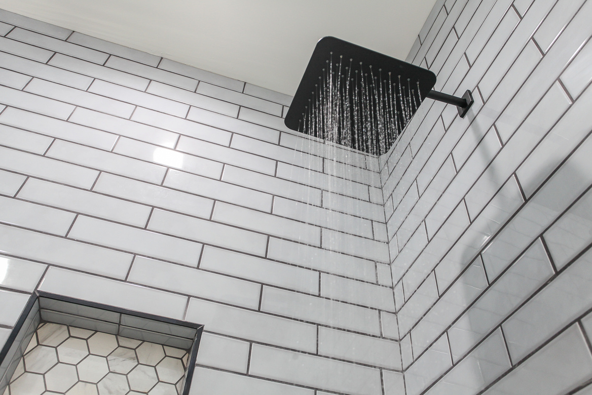 Refresh after a day exploring in the primary bathroom’s tiled shower with a rainfall shower head at Robbin’s Nest on Snowbird Creek.